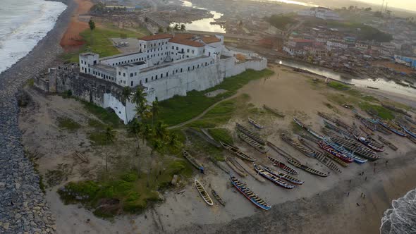 Aerial shot of the Elimina castle in Ghana during sunset