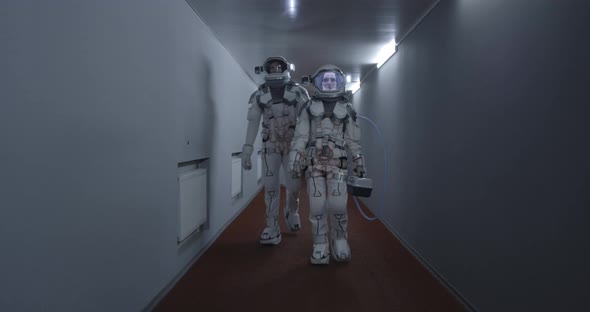 Astronauts Walking Down a Corridor