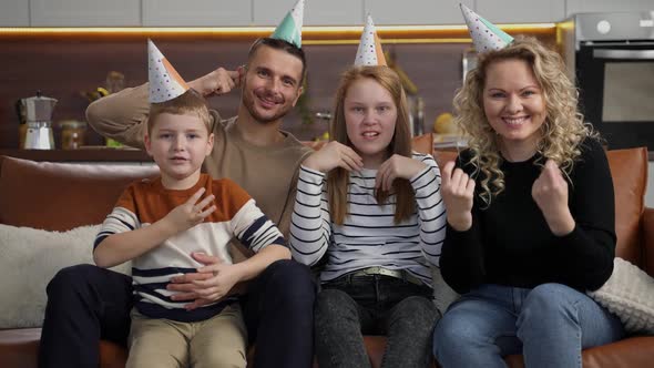 Smiling Deaf Couple with Kids During Video Chat