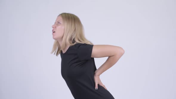 Young Stressed Blonde Woman Having Back Pain