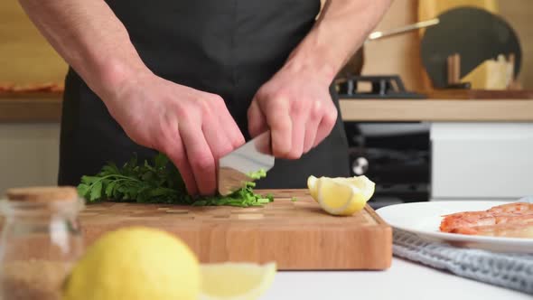 Man Chef Professionally Slices Parsley on Cutting Board