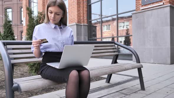 Online Shopping On Tablet By Woman Sitting Outside Office