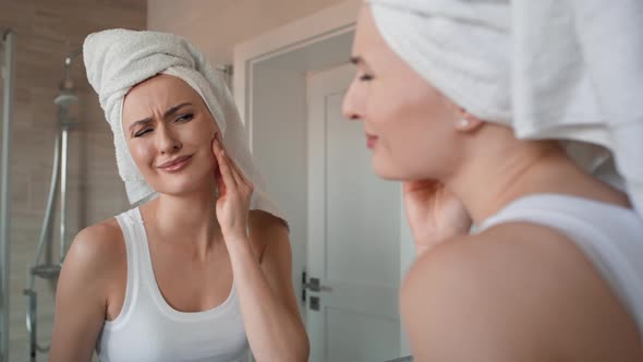 Caucasian woman  in the bathroom having a strong toothache or bruxism. Shot with RED helium camera i