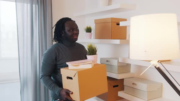 Young African American Man Moving in To the New Appartment