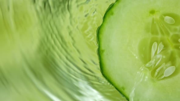 Super Slow Motion Shot of Splashing Water on Rotating Cucumber Slice at 1000Fps.