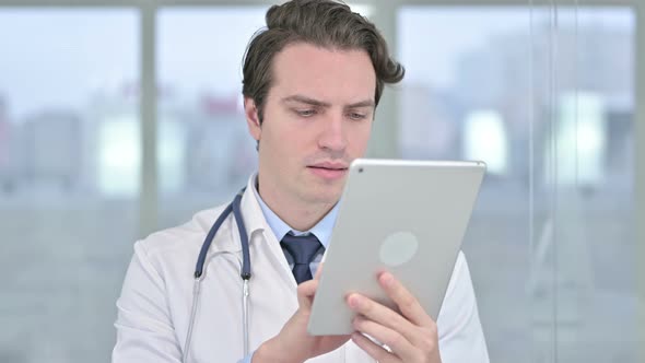 Portrait of Professional Young Male Doctor Using Tablet