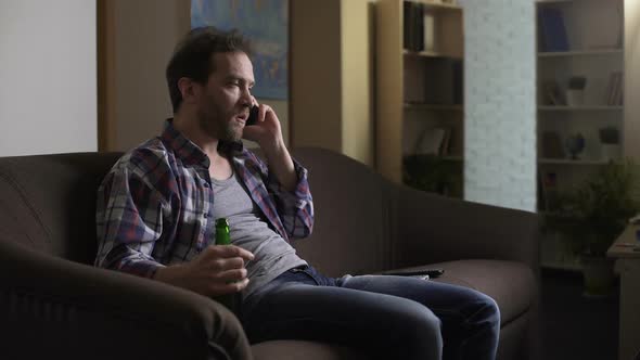 Messy Guy Arguing Over Mobile Phone, Drinking Beer from Bottle, Frustration