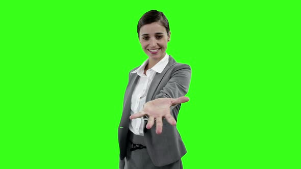 Businesswoman gesturing against green screen