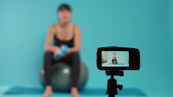 Trainer Filming Workout Video on Camera to Give Fitness Advice