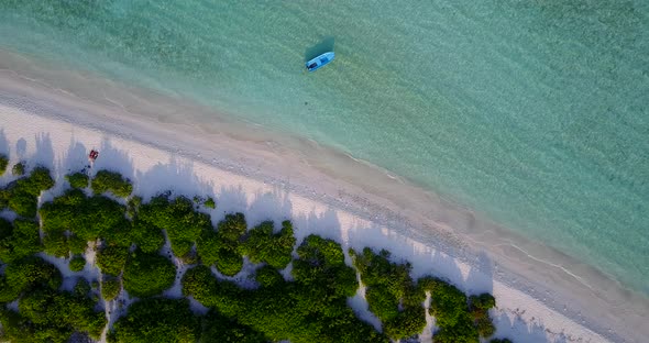 Wide angle overhead island view of a white sand paradise beach and blue ocean background in hi res 4