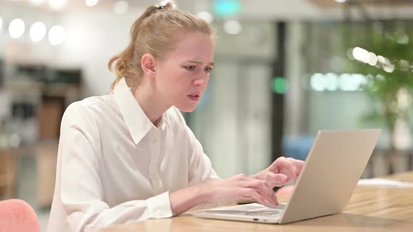 Upset Young Businesswoman Having Loss on Laptop