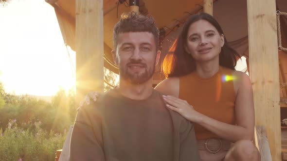 Couple Posing Sitting by Glamping