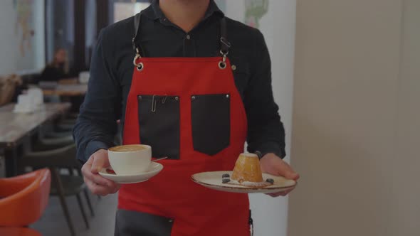 Waiter Is Carrying Coffee and Dessert To Male Customer and Putting on Table