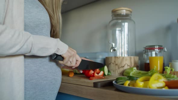Pregnant woman preparing vegetables to eat. Shot with RED helium camera in 8K