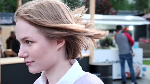 Cheerful Young Woman with Short Hair Waved By Light Wind