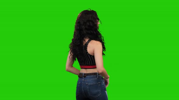 Sad Caucasian woman with long curly hair turns on green screen