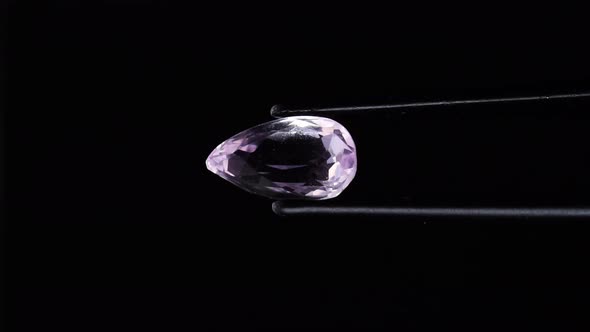 Natural Pink Kunzite Gemstone in Tweezer on the Turn Table