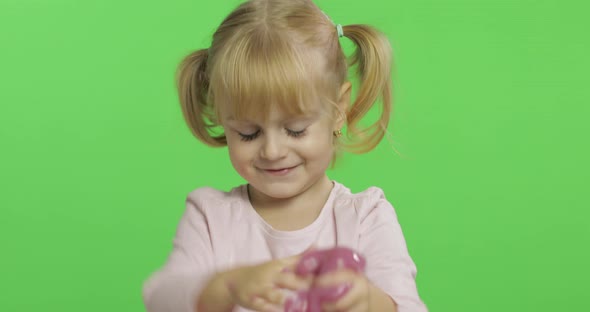 Kid Playing with Hand Made Toy Slime. Child Having Fun Making Pink Slime
