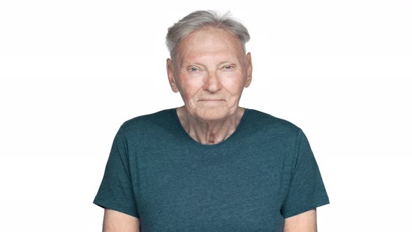 Portrait of Happy Old Aged Man 70s Having Gray Hair in Basic Tshirt Looking at Camera with Sincere