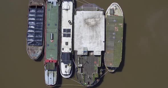 Top down aerial rising view of boats moored on the River Medway, Kent, UK