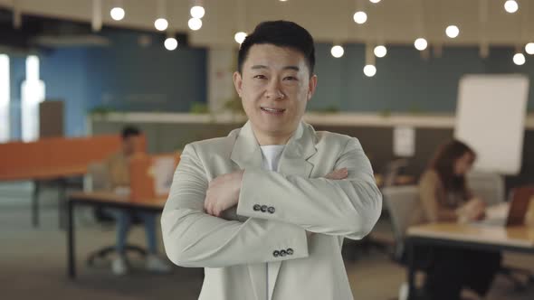 Caucasian Businessman in a Good Mood Looking Into Camera and Smiling Indoors