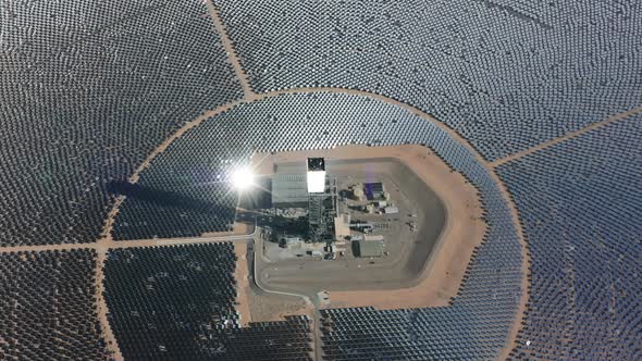 Drone Rotating Above Huge Circle of Solar Panels and Power Station in Nipton USA