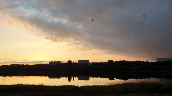 Panoramic view of colorful sunset clouds over the lake