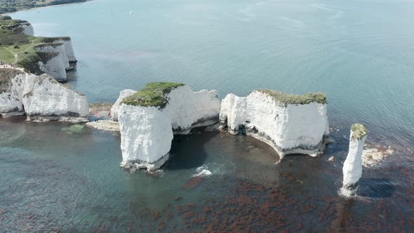 Close up circling drone shot of old harry rocks white cliff rock formations in the UK