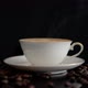 Cup of cappuccino and coffee beans on a black surface. - VideoHive Item for Sale