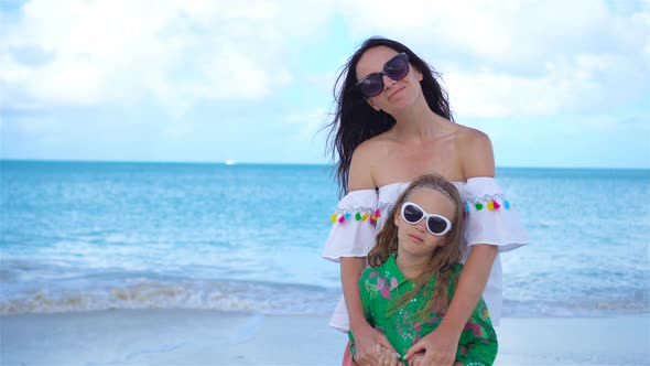 Beautiful Mother and Daughter on Caribbean Beach. Portrait of Family on Summer Vacation