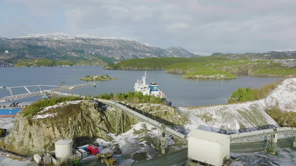 Industrial Freighter Boat Docked At Aggregate Quarry In Norway, Aerial