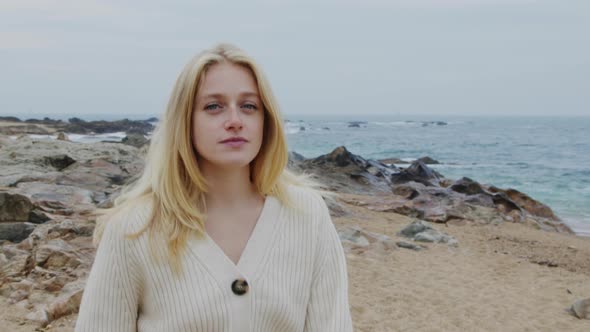 Young Woman Is Promenading On Ocean Coast