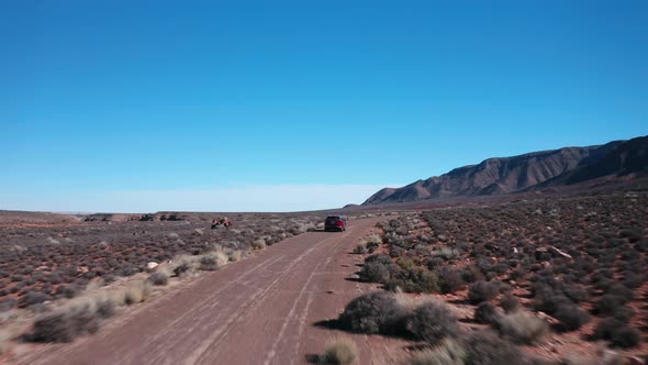 Red car driving the desert