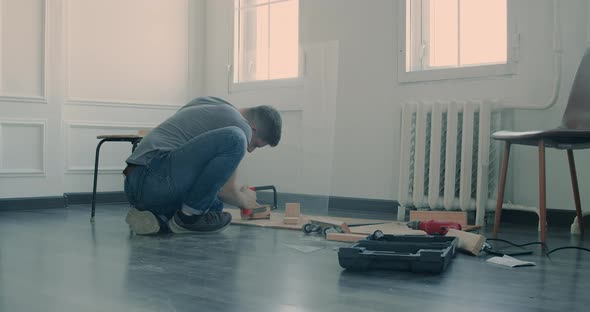 Man is Building Furniture Himself Making Renovation at Home