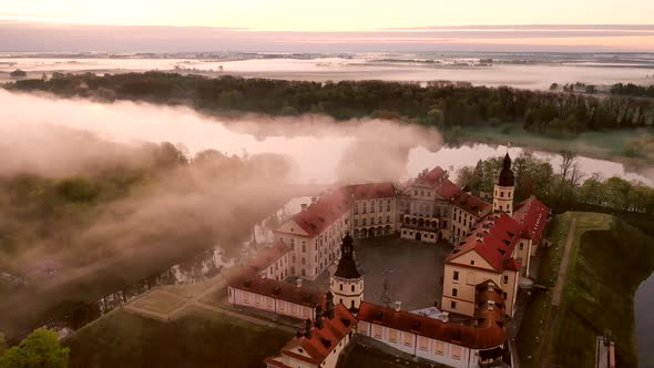 Amazing Dawn in the Foggy Nesvizh, Fog Over the River. Nesvizh. Ancient Castle . Belarus