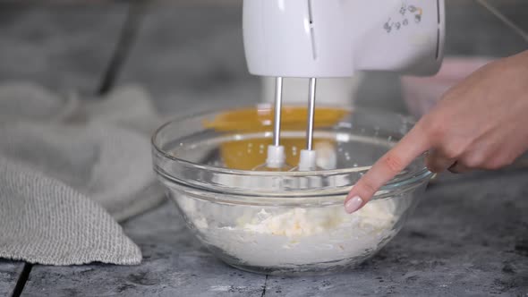 Woman Beating Cream with Mixer Machine