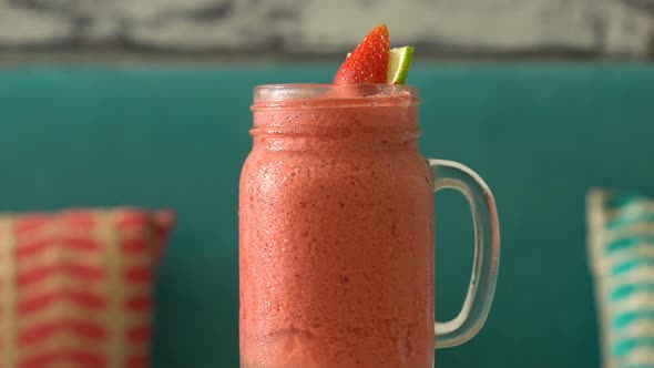 Fresh Tropical Organic Strawberry Smoothie Rotate on Table.