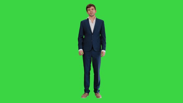 Confident Businessman Showing Thumbs Up and Ok Gestures on a Green Screen, Chroma Key