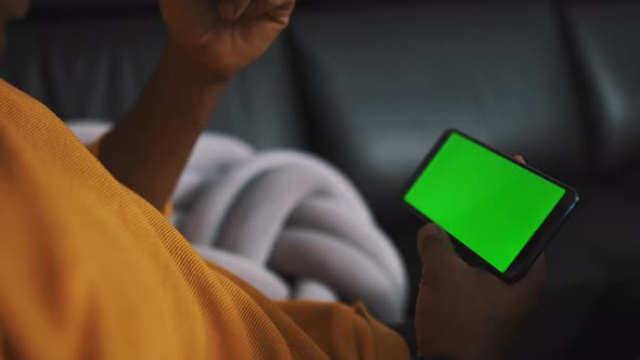 Close Up Smartphone with Green Screen in the Hands of African American Black Man