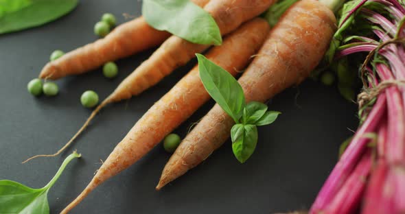 Video of fresh vegetables of beetroot and carrot with copy space over grey background