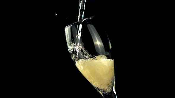 Champagne with Foam and Air Bubbles is Poured Into the Glass