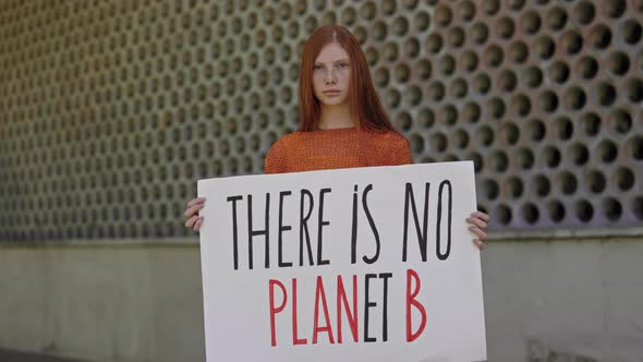 Female Activist Holding There is No Planet B Banner