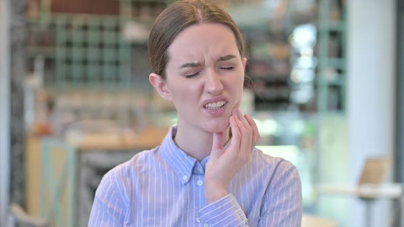 Portrait of Young Businesswoman with Toothache