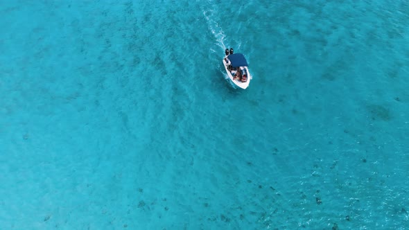 Aerial View of Moving Boat Along a Rock Crystal Rock Mauritius