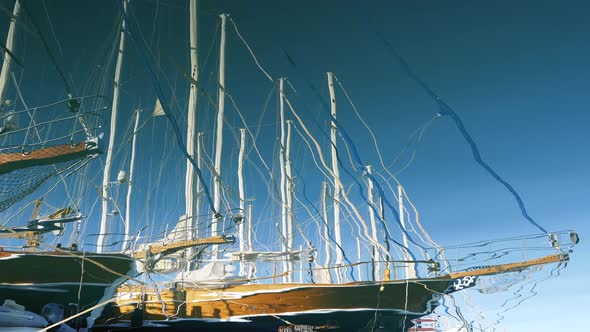 Reflection in the Water of a Beautiful Expensive Yacht. Parking for Yachts in the Port of the Resort