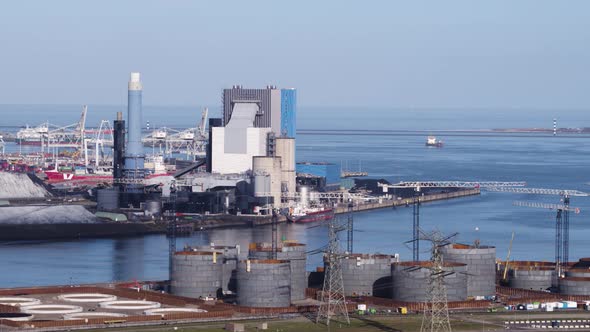 Construction cranes setting up oil tank farm, Rotterdam seaport, Holland
