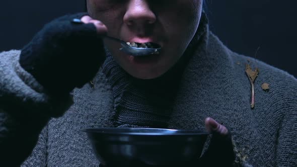 Homeless Woman Eating and Trembling With Cold, Food Charity for Poor People