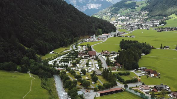 Amazing Aerial Shot of Beautiful Alpine Camping Site and River on Foot of the Mountain in Engelberg