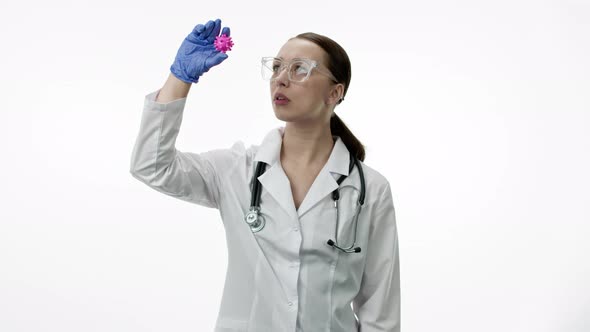 Sexy Female Lab Technician Exploring Covid-19 Virus Cell in Research Laboratory