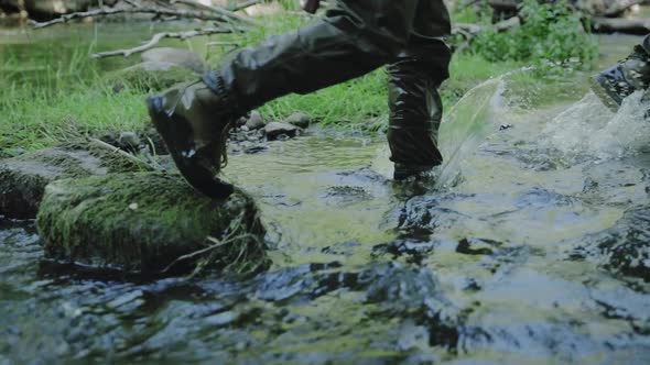 Fisherman Walking Through The River Water